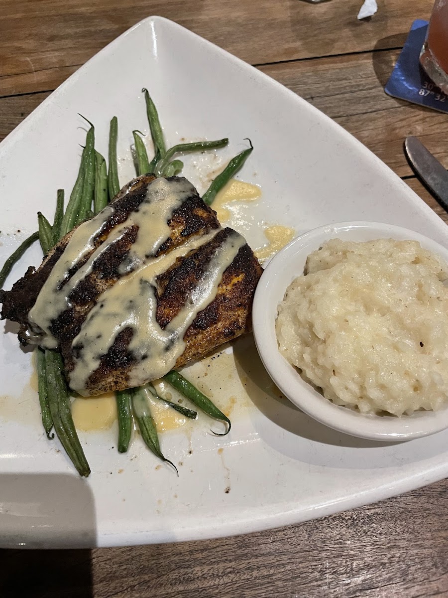 Blackened Red Fish with Louisiana Hollandaise Sauce, creamy Parmesan risotto, and green beans.