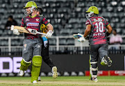 Eoin Morgan (L) and Gihahn Cloete (R) of the Tshwane Spartansrun between wickets during the Mzansi Super League match against the Jozi Stars at Bidvest Wanderers Stadium in Johannesburg on December 11, 2018.