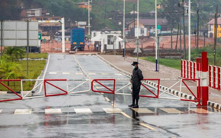 A Rwandan police officer stands guard at the barrier of the Gatuna one-stop border post at Gicumbi, northern Rwanda, January 31 2022. Picture: REUTERS/Jean Bizimana