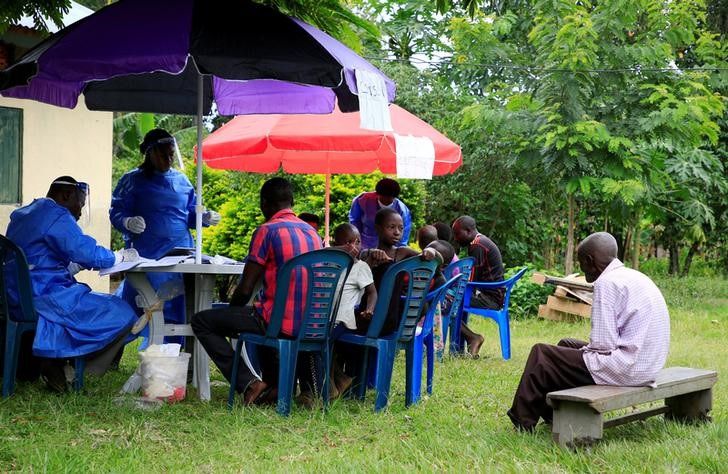 Ugandan health workers speak to members of the community before carrying out the first vaccination exercise against the ebola virus in Kirembo village, near the border with the Democratic Republic of Congo in Kasese district, in this file photo,