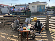 Boys play chess in Khayelitsha. A new generation of players claim chess helps them with their academic work, giving them focus, discipline and drive.