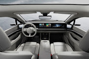 The car features a dashboard-wide digital infotainment system.