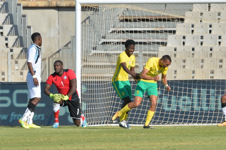 Ryan Moon (R) of South Africa celebrates his goal with teammate Siphelele Ntshangase (C) during the CHAN 2018 Qualifying - 2nd Leg match between Bafana Bafana and Botswana at Moruleng Stadium on July 22, 2017 in Rustenburg, South Africa.