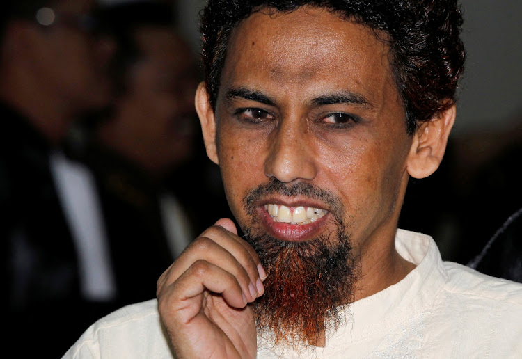 Indonesian militant Umar Patek walks after reading his final defence at the West Jakarta court May 31, 2012. Prosecutors last week sought life in prison for Patek, accused of making bombs that exploded at Bali nightclubs packed with Australian tourists in 2002, killing 202 people. Patek is also accused of mixing chemicals for 13 bombs that detonated in five churches in Jakarta on Christmas Eve, 2000 and killed around 15 people.