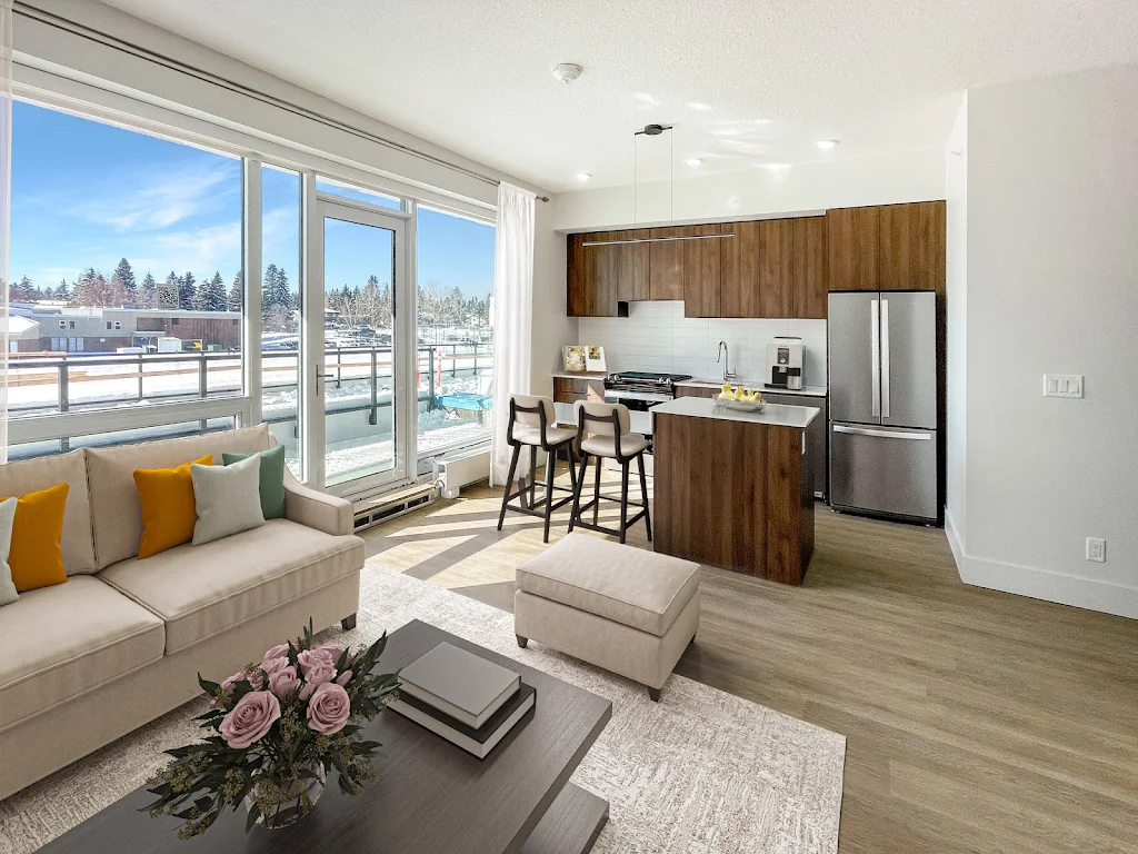 Modern apartment interior with open-plan kitchen, living area, large windows, and balcony view, decorated in neutral tones.