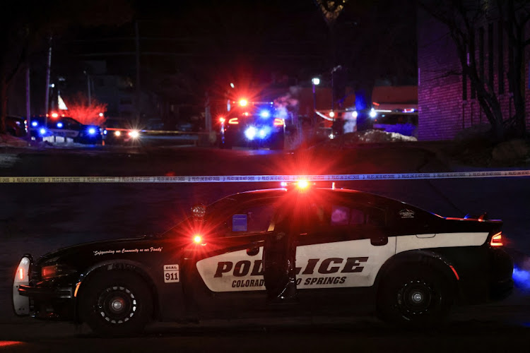 A police officer sits in their vehicle while responding to a mass shooting at the Club Q gay nightclub in Colorado Springs, Colorado, US, on November 20 2022.