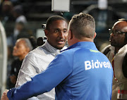 Bidvest Wits coach Gavin Hunt (R) shakes hands with his Chippa United counterpart Rulani Mokwena after their match at Bidvest Stadium on March 7 2020.  