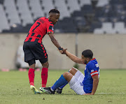 Orebotse Mongae of TS Galaxy FC pulls up Travis Graham of Maritzburg United during the DStv Premiership match at Mbombela Stadium on April 02, 2023.