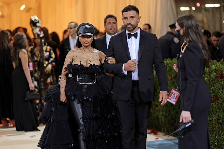 Nicki Minaj arrives on the carpet with designer Ricardo Tisci.