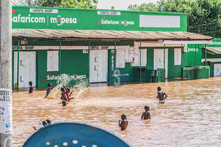 Children from Mororo Village play with water after River Tana burst its banks following heavy rainfall in the area on April 27, 2024.