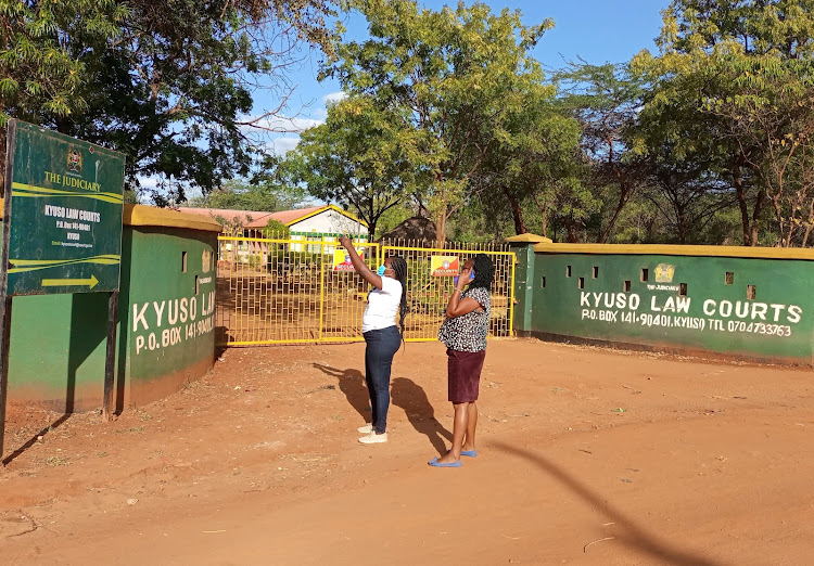 Two members of the public standing outside the Kyuso law courts last Wednesday.