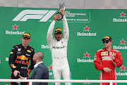 Lewis Hamilton celebrates his Brazilian GP victory ahead of second-placed Max Verstappen (left) and third-placed Kimi Raikkonen (right).
Picture: REUTERS