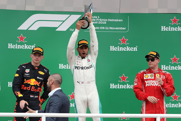 Lewis Hamilton celebrates his Brazilian GP victory ahead of second-placed Max Verstappen (left) and third-placed Kimi Raikkonen (right). Picture: REUTERS