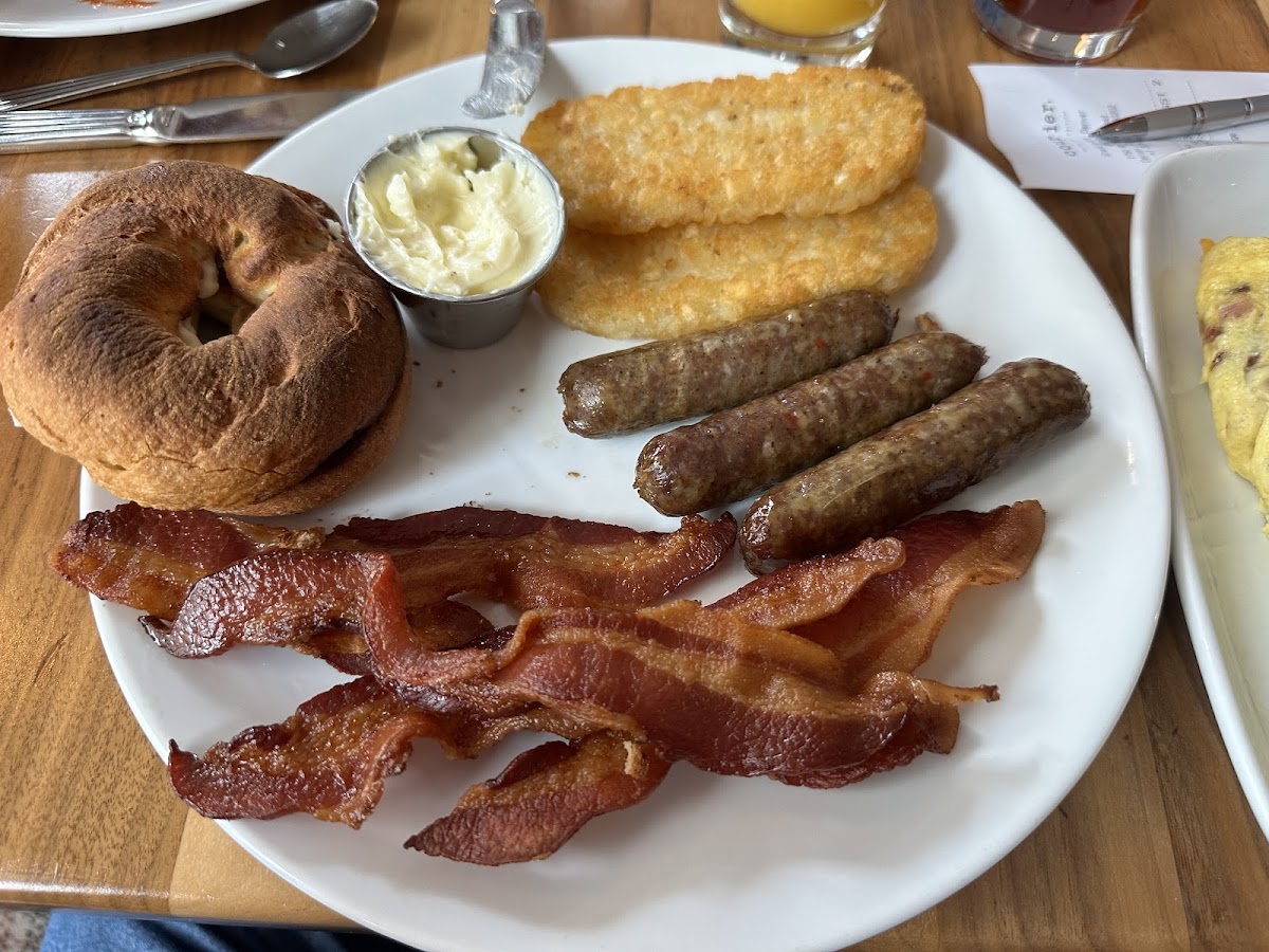 Canyon Bakehouse Bagel, hash browns, bacon, and sausage