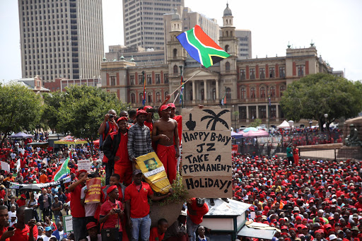 Protesters wish President Zuma and happy birthday and ask him to take a hike.