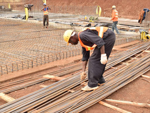 Workers at the Chemususu Dam construction site on February 21, last year / RITA DAMARY