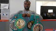 Ilunga Makabu shows off championship belts he has earned in his pro career.