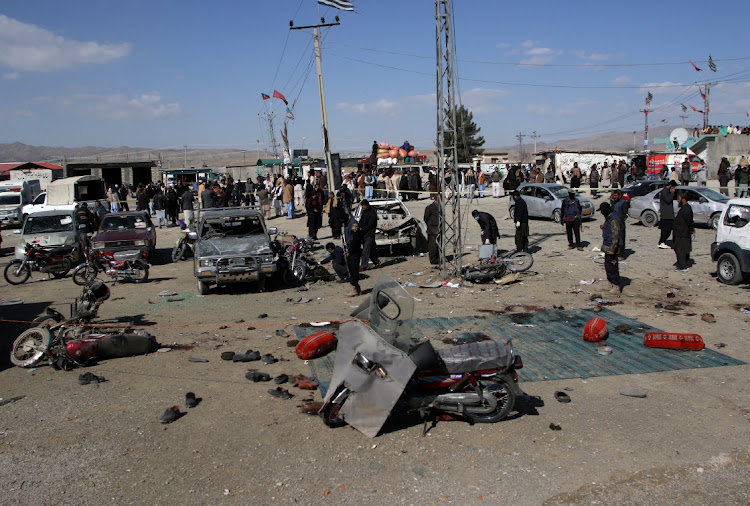 Members of a bomb disposal squad examine the site of a blast in Khanozai, Balochistan, Pakistan, February 7 2024. Picture: NASEER AHMED/REUTERS