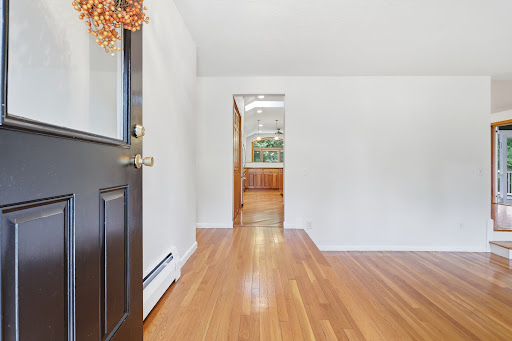 Entryway with black door and visible kitchen - Prestige property for sale in Acton, 3 bedrooms