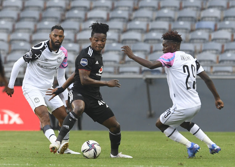Brice Ambina of Cape Town City challenges Kwame Peprah of Orlando Pirates during the DStv Premiership 2021/22 match between Orlando Pirates and Cape Town City.