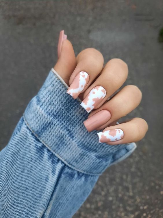 Full picture of a  lady rocking the brown cow print nails