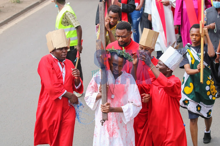 Morphat Mureithi carries the cross acting as Jesus during the procession by Holy Family Basilica, Nairobi.