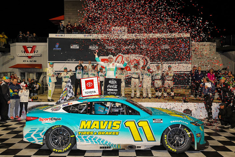 Denny Hamlin celebrates in victory lane after winning the NASCAR Cup Series Toyota Owners 400 at Richmond Raceway on March 31, 2024 in Richmond, Virginia.