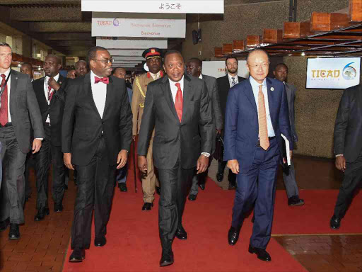 President Uhuru Kenyatta with the President of the African Development Bank, Akinwumi Adesina and the President of the World Bank Jim Yong Kim during the TICAD 6 roundtable on the role of the Private Sector in Africa's economic transformation at KICC, Nairobi yesterday.Photo PSCU