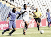 NO WAY THROUGH: Moroka Swallows striker Collins Mbesuma, right, shields the ball from Maritzburg United's Bheka Phakathi during their Premiership match at Dobsonville Stadium in Soweto yesterday. Swallows won 2-0. PIC: VELI NHLAPO. 18/10/2009. © Sowetan.