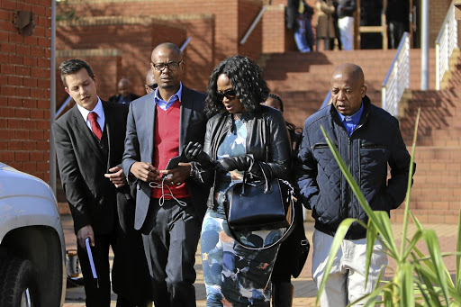 Media mogul Given Mkhari and his wife Ipeleng exit the Randburg Magistrate's Court in Johannesburg after the pair laid assault charges against each other following an alleged fight at the weekend.