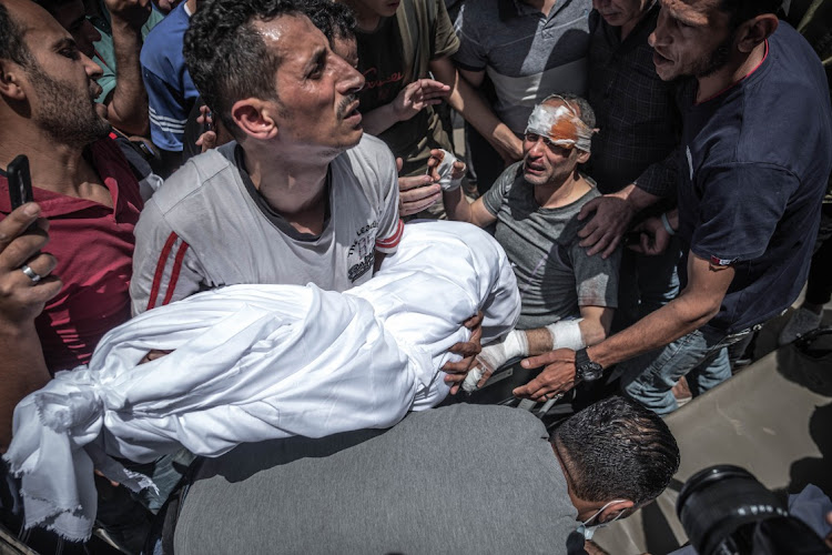 A Palestinian survivor mourns his children who were killed in a Israeli raid on Gaza City, Gaza, May 16 2021. Picture: FATIMA SHBAIR/GETTY IMAGES