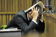 Oscar Pistorius bows his head as he listens to evidence during his murder trial in the High Court in Pretoria this week.