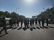 Metro police keep a watchful eye over pro-Zandile Gumede supporters at the ANC provincial headquarters in Durban on Thursday.