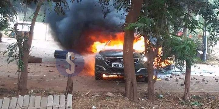 A police vehicle torched by demonstrators at Emali Town in Makueni County on July 12, 2023