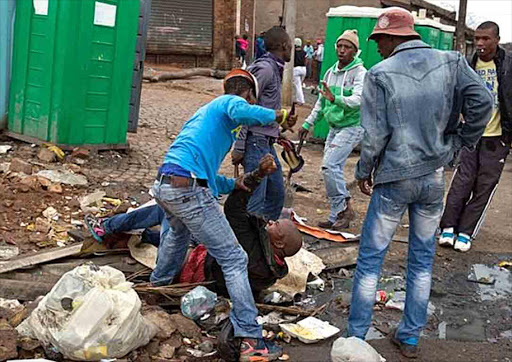 Sithole was cornered on a rubbish-strewn Alexandra street early yesterday morning. The Sunday Times rushed him to Edenvale Hospital, where he succumbed to his injuries