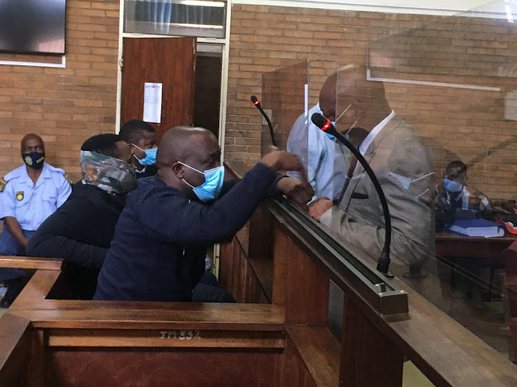 Former MEC is agriculture land reform and rural development, Mandla Msibi talking to his relative while he appears in the Nelspruit magistrates court.