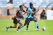 Richards Bay FC player Thulani Gumede is challenged by Orlando Pirates players Patrick Maswanganyi (left) and Deon Hotto during the Carling Knockout, Quarterfinal match at Moses Mabhida Stadium on November 04, 2023.