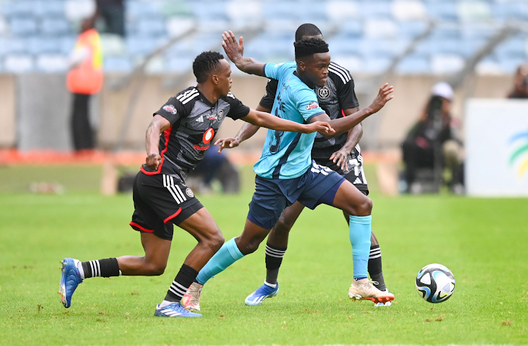 Richards Bay FC player Thulani Gumede is challenged by Orlando Pirates players Patrick Maswanganyi (left) and Deon Hotto during the Carling Knockout, Quarterfinal match at Moses Mabhida Stadium on November 04, 2023.