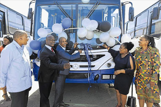 NEW WHEELS: Eastern Cape premier Phumulo Masualle cuts the ribbon on one of 30 new buses added to the Mayibuye Transport Corporation (MTC) fleet. On his left is MTC board chairman Vanguard Mkosini and in the foreground BCM mayor Alfred Mtsi. Right are transport MEC Weziwe Tikana and MTC CEO Ntombizine Madyibi Picture: STEPHANIE LLOYD