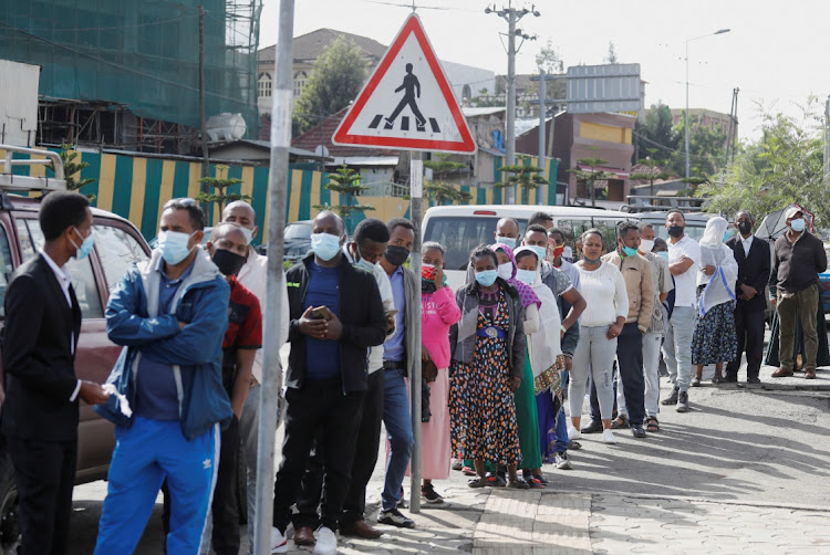 People wait outside a polling station to vote during the Ethiopian parliamentary and regional elections, in Addis Ababa, Ethiopia, June 21, 2021.