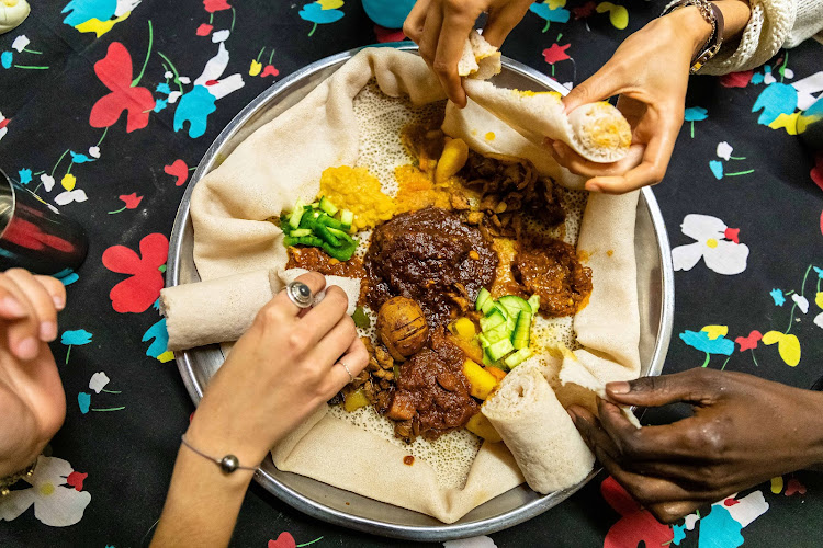 Guests enjoy 'injera' from Little Ethiopia.