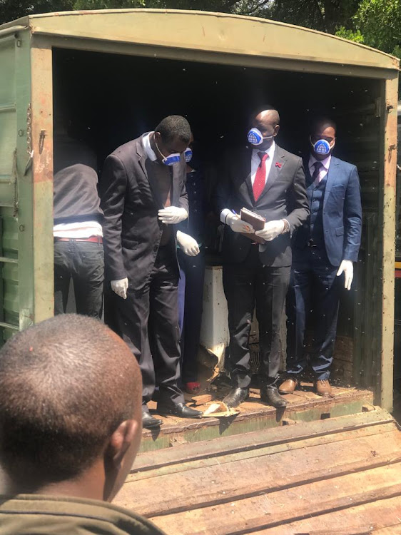 Court officials inspecting confiscated giraffe and Zebra meat at Kibera Law Courts