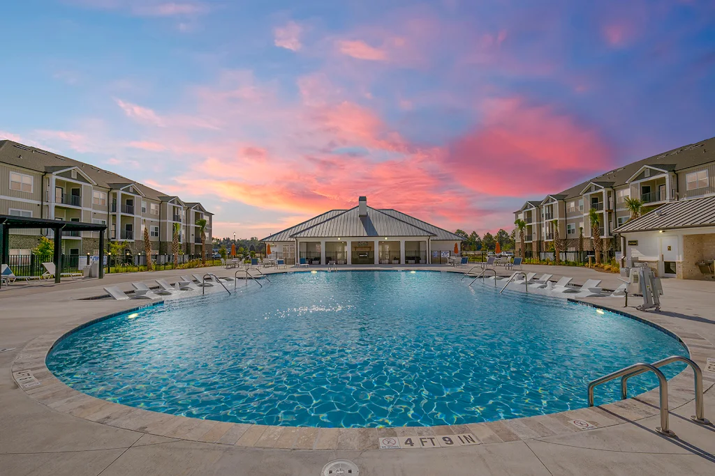 Resort-style swimming pool at dusk