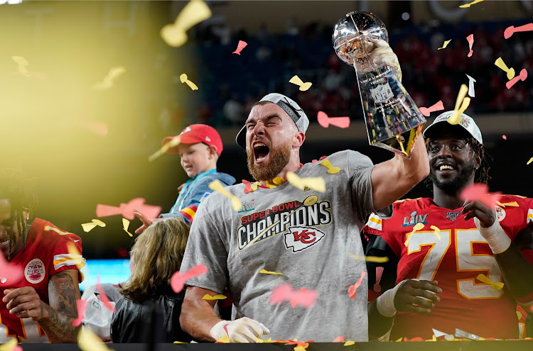 Kansas City Chiefs' Travis Kelce and Cam Erving celebrate with the Vince Lombardi trophy after winning the Super Bowl LIV at the Hard Rock Stadium, Miami, Florida, U.S. - February 2, 2020.