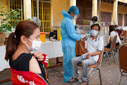 A Cambodian army member vaccinates a person inside a red zone with strict lockdown measures, amidst the latest outbreak of the coronavirus disease (Covid-19), in Phnom Penh, Cambodia.