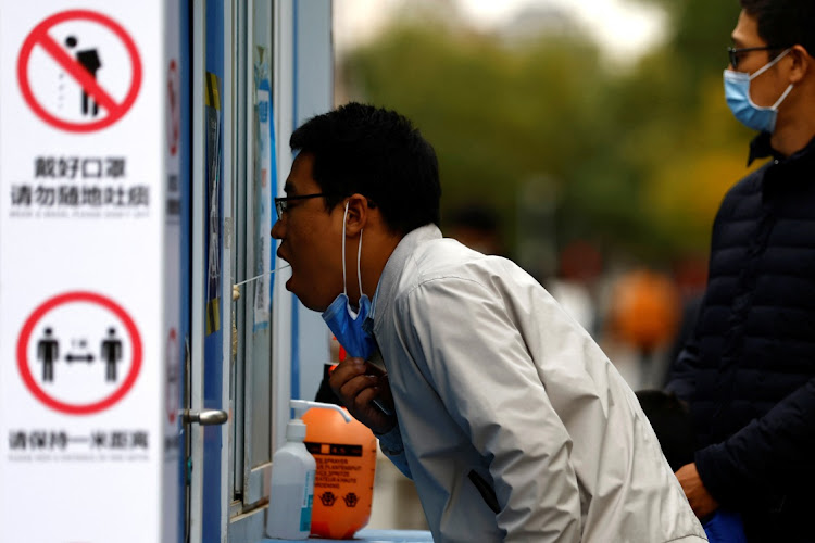 A man has his swab sample taken for a test for the coronavirus disease (Covid-19) at a testing booth, in Beijing, China October 27, 2022.