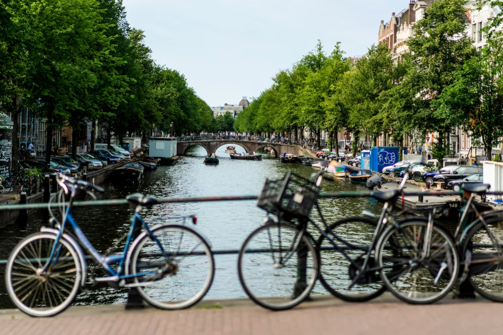 Bicycles on the street in Amsterdam in front of the canal