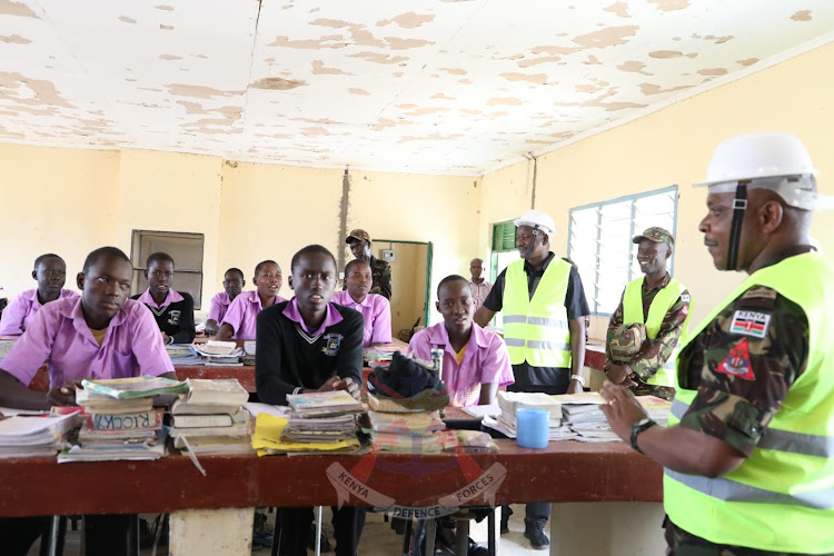 KDF Construction Engineers Brigade Commander Brigadier Joseph Mutua interacts with pupils during an inspection tour to assess the ongoing construction of schools in North Rift on July 3, 2023