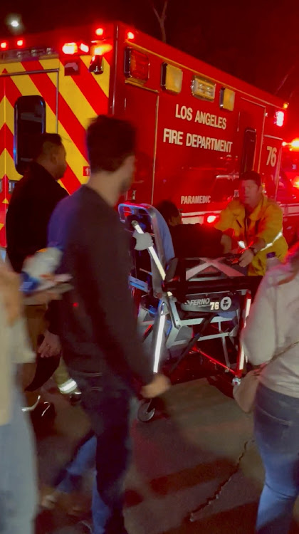 A man is transported into an ambulance after comedian Dave Chappelle was attacked on stage during stand-up Netflix show at the Hollywood Bowl, in Los Angeles.