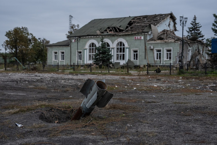 An unexploded missile lies embedded in the ground outside a train station on October 9, 2022 in Donetsk, Ukraine.